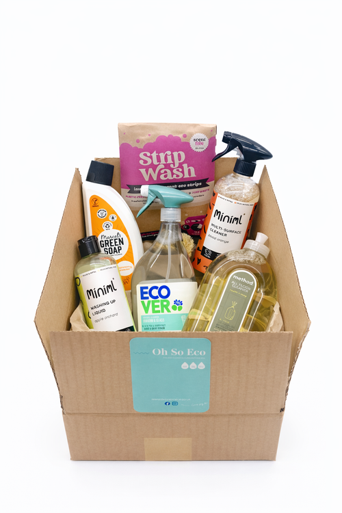 Box of cleaning products including bottles and a spray can on a white background